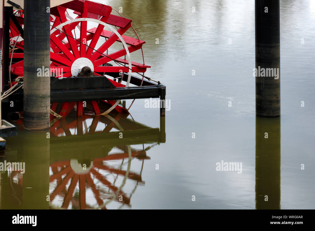 Paddle wheel on a docked steamboat reflect in the Willamette River waters in Salem, Oregon Stock Photo