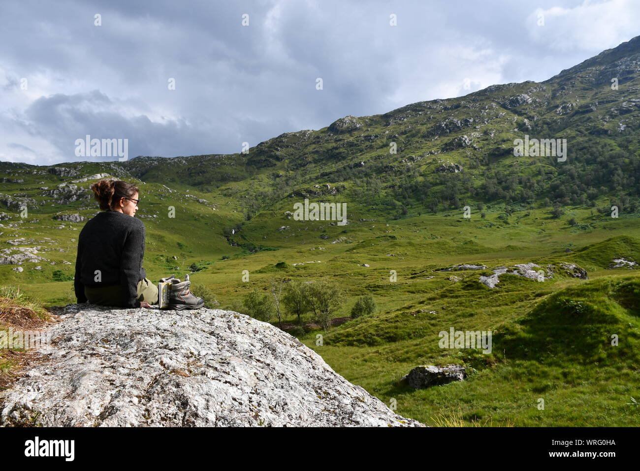 Solo traveller enjoying the scottish highlands Stock Photo
