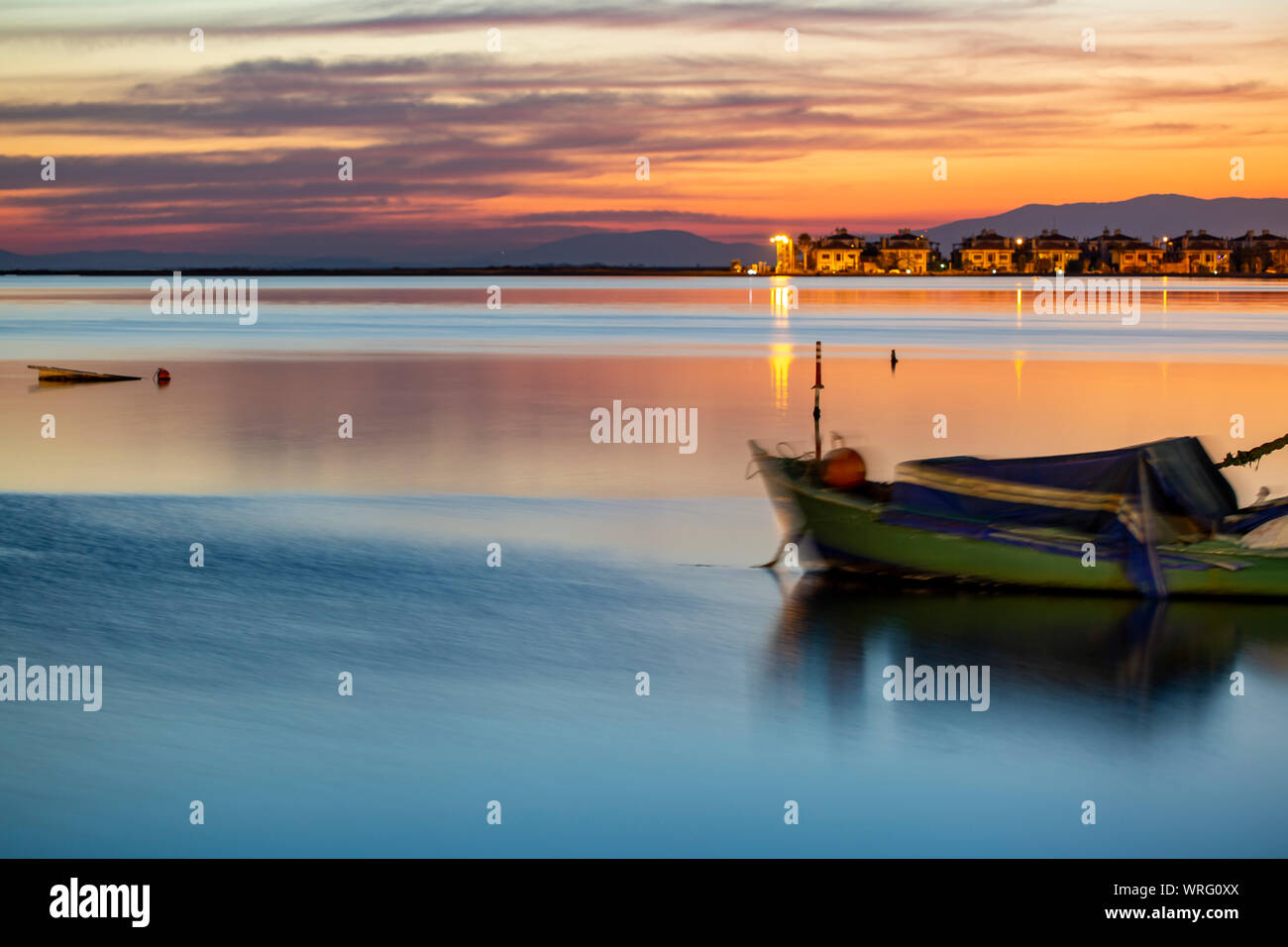 A Sailing Boat with Misty Sunset and Reflection on Water Stock Photo ...