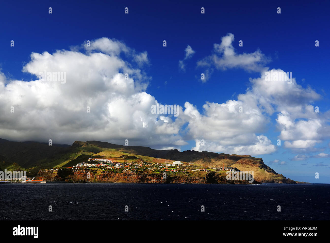 View Of Atlantic Ocean By Hill Against Cloudy Sky Stock Photo