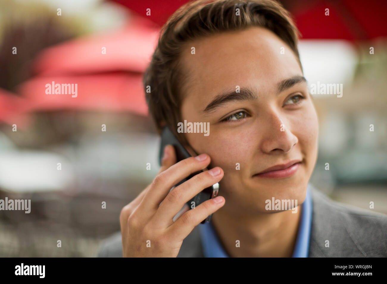 Young man talks on cell phone Stock Photo