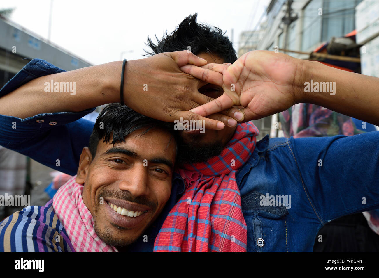 DHAKA, BENGAL BANGLADESH - 26 JANUARY 2019: Two young friends hugging in the street in Bangladesh Stock Photo