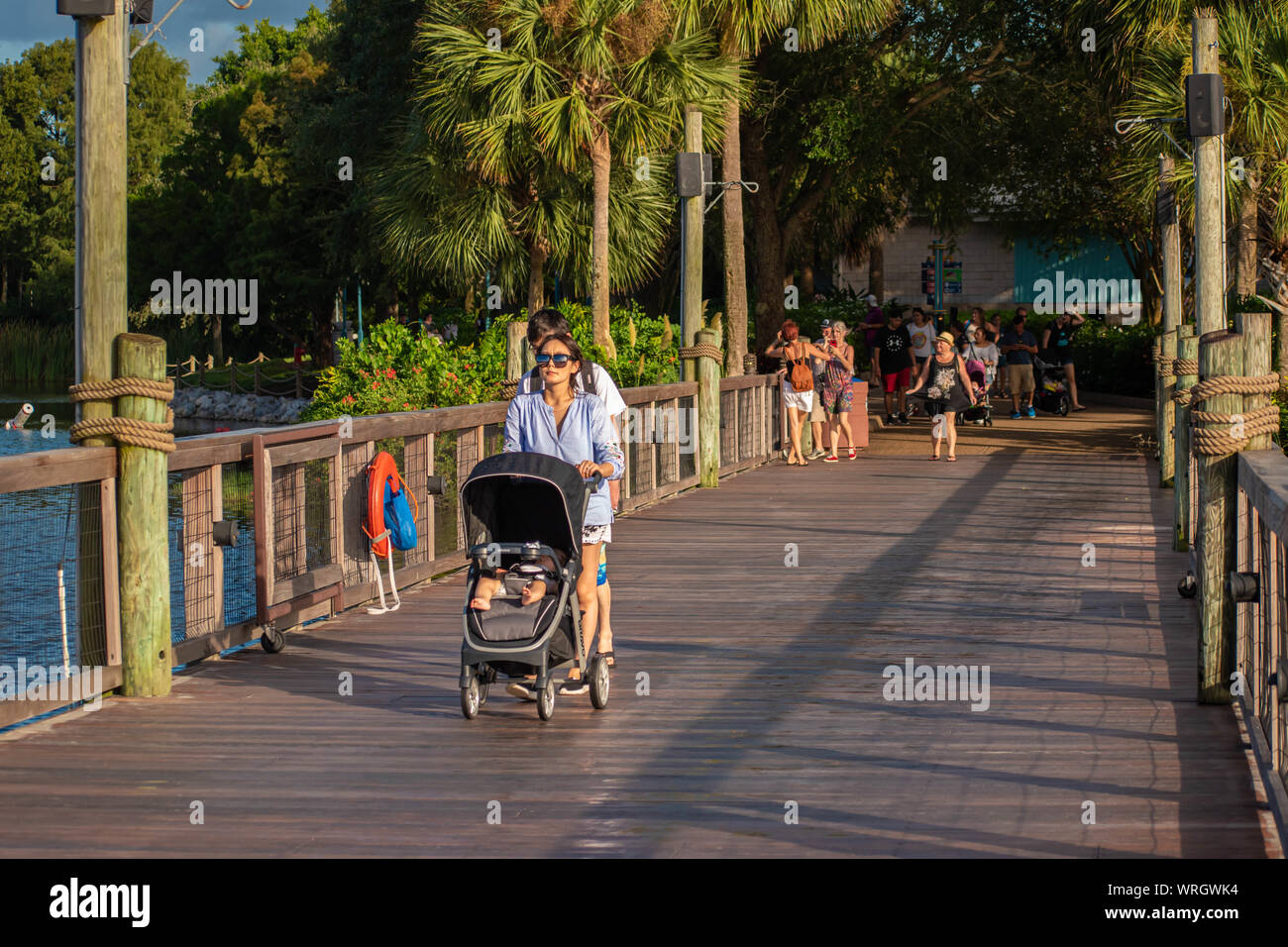 Orlando, Florida. August 31, 2019. Japanese family walking on Seven Seas lagoon bridge at Seaworld Stock Photo