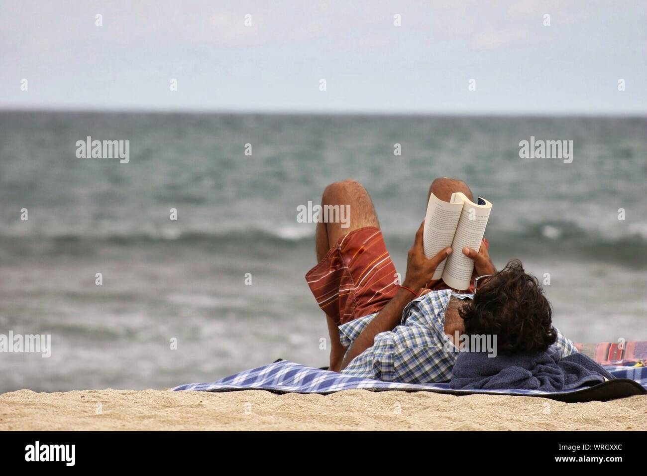Man on beach towel hi-res stock photography and images - Alamy