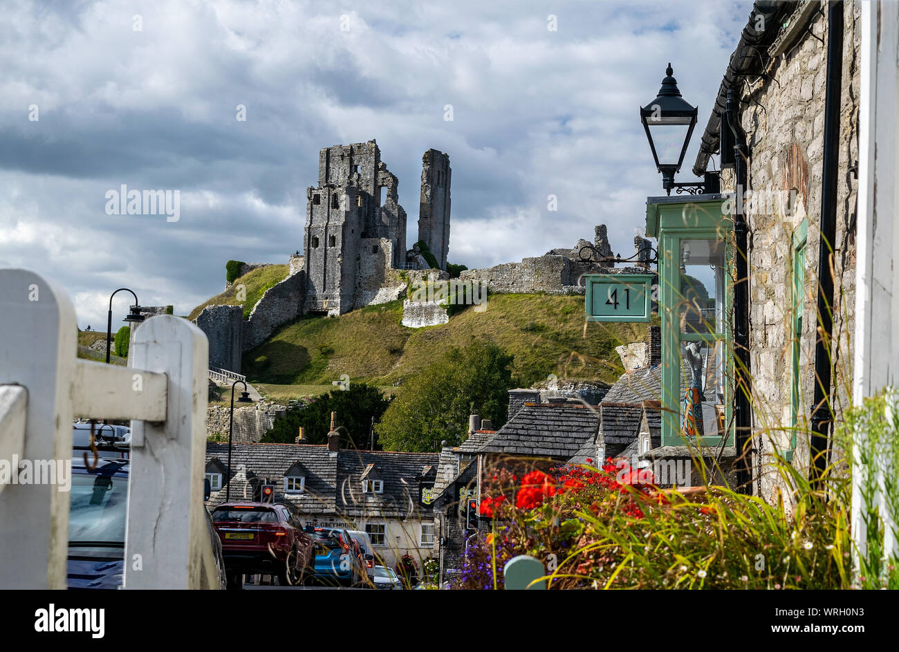 The historic village of Corfe, Dorset, England, UK . The ruined Castle  stands on the Purbeck hills overlooking the village Stock Photo