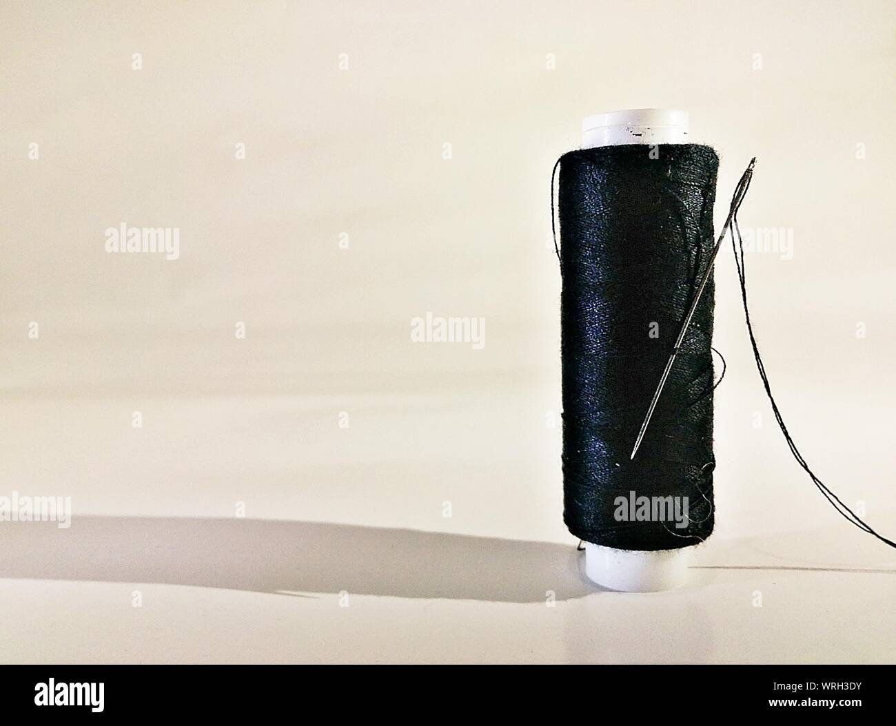 Threadneedle Against Wall Thread spool with needle hi-res stock photography and images - Alamy