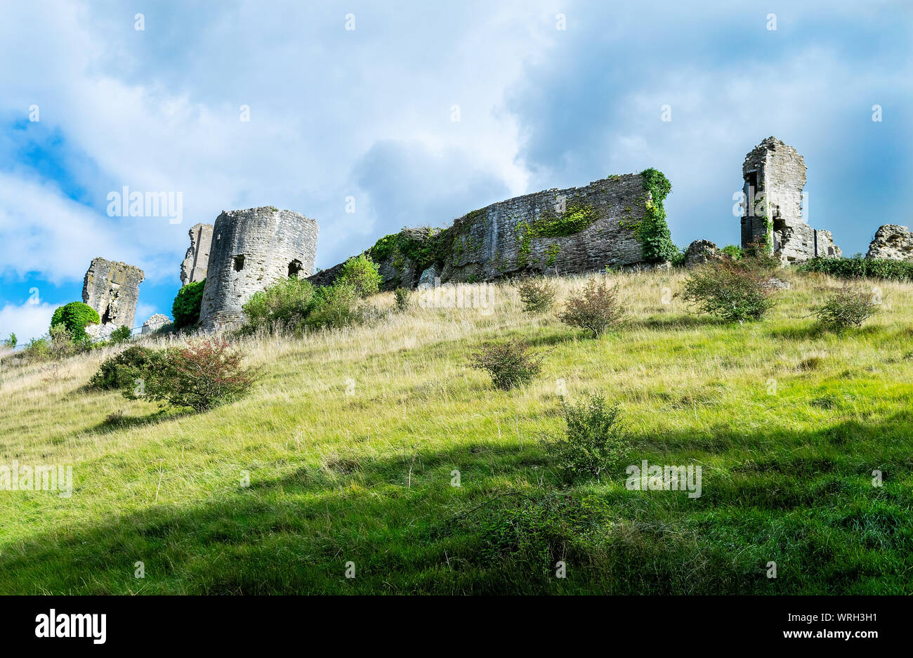 The historic village of Corfe, Dorset, England, UK . The ruined Castle  stands on the Purbeck hills overlooking the village Stock Photo