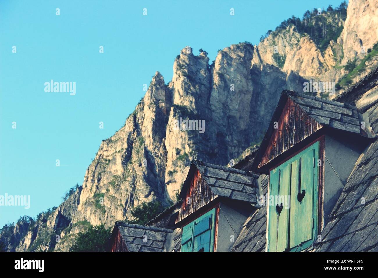 Exterior Of House With Dormer Windows Against Mountains Stock Photo