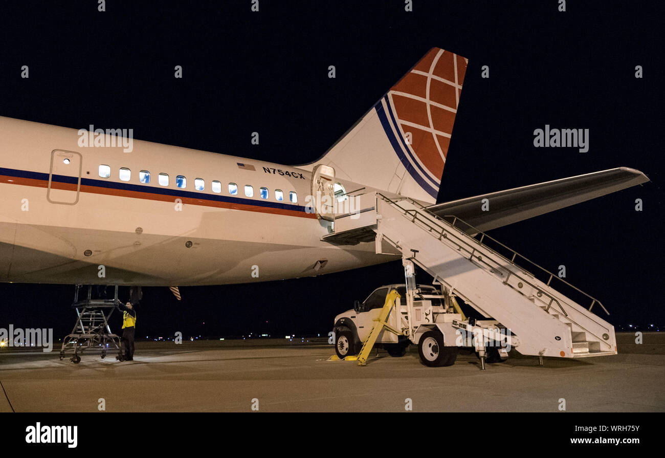 A step truck sits parked at the aft section of an Air Transport International Boeing 757-200 Sept. 8, 2019, at Dover Air Force Base, Del. Part of the Civil Reserve Air Fleet program, this ATI aircraft is equipped with 42 passenger seats. It was contracted to transport cargo and 30 Team Dover members to Fairchild AFB, Wash., participating in Mobility Guardian 2019. “This mission is multidimensional and will provide a greater understanding of the commercial airlift capabilities and requirements across Air Mobility Command and the commercial airlift enterprise,” said Maj. Adam Crane, AMC Headquar Stock Photo
