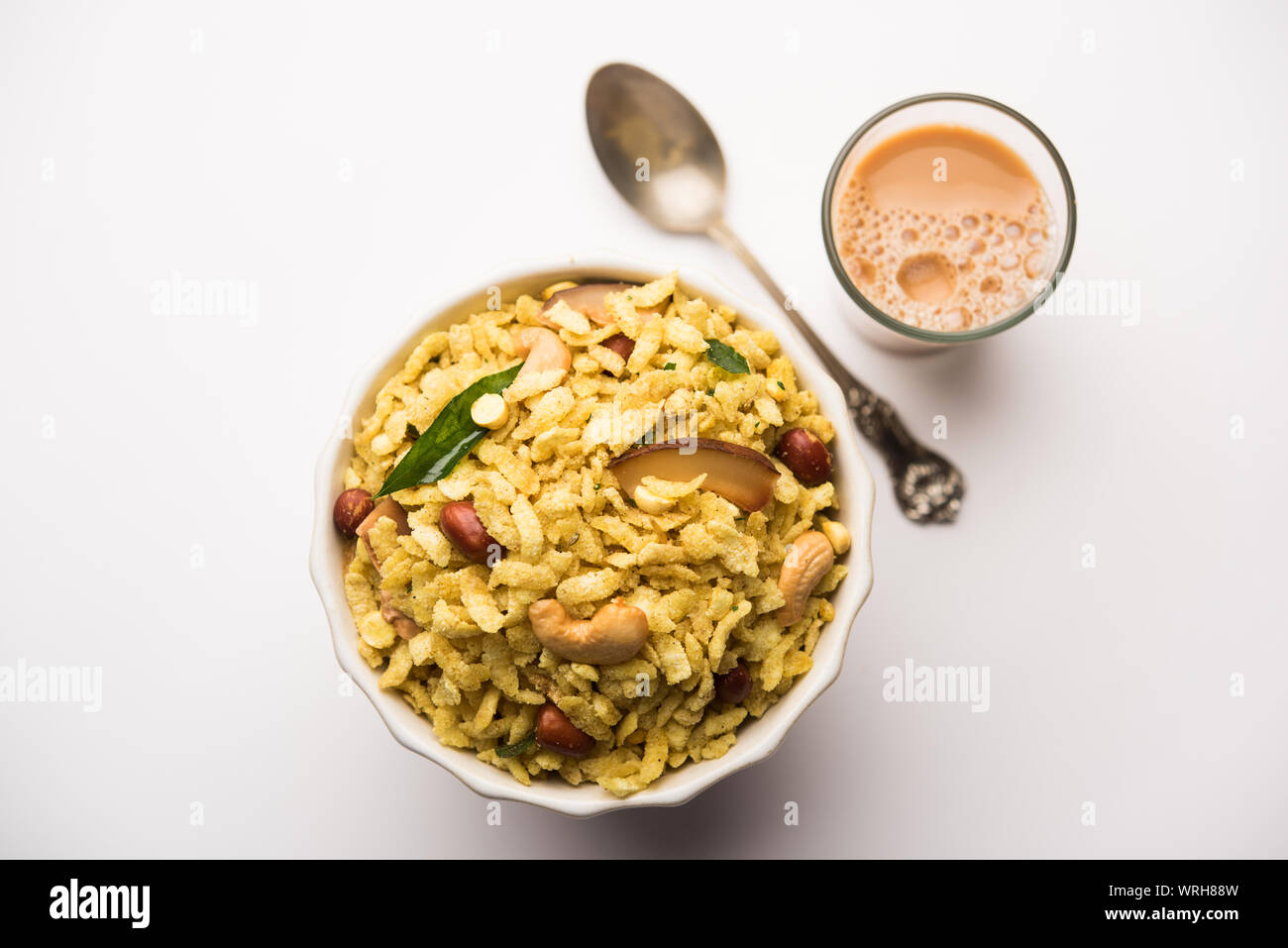 Jada Poha Namkeen Chivda / Thick Pohe Chiwda is a jar snack with a mix of sweet, salty and nuts flavours, served with tea. selective focus Stock Photo