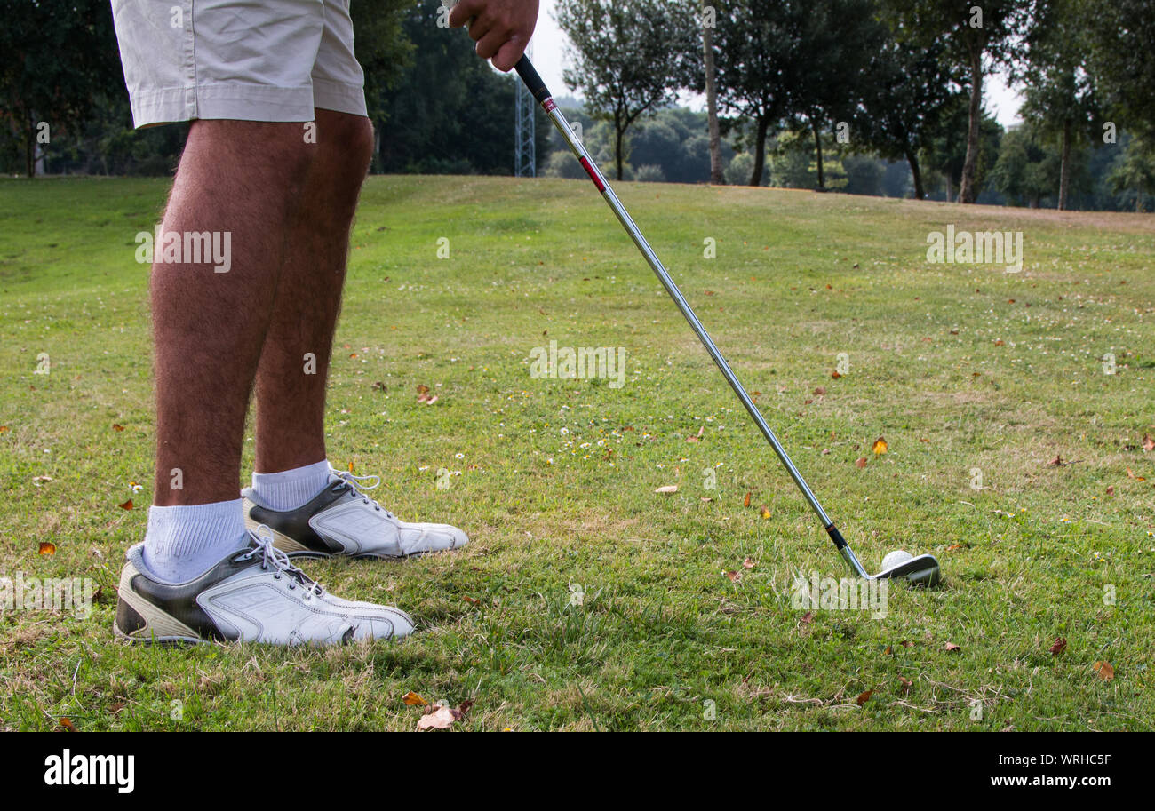 golfers playing on golf course Stock Photo