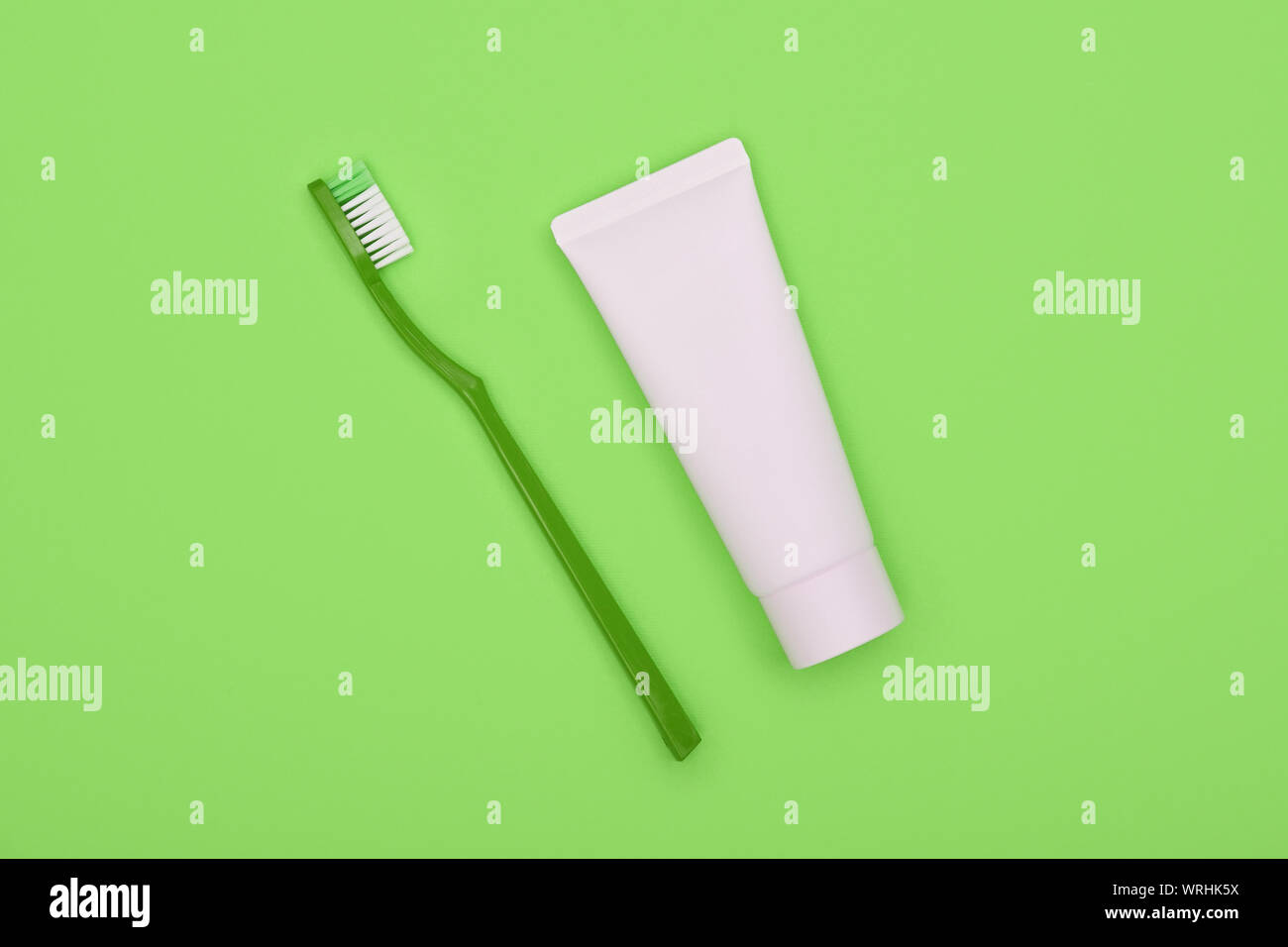 Close up one white toothpaste tube and plastic toothbrush on natural ...