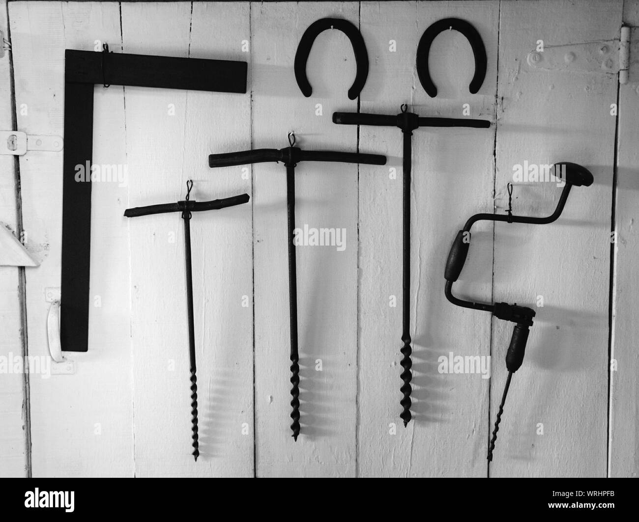 Old Iron Work Tools Hanging On Wooden Door Stock Photo 272683471