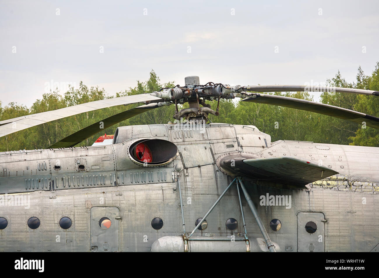 An old military helicopter painted gray closeup. Stock Photo