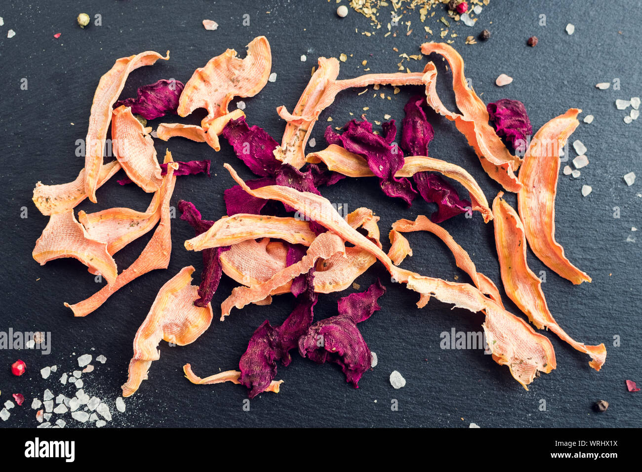 Healthy homemade vegetable chips from beetroot and carrot with salt and