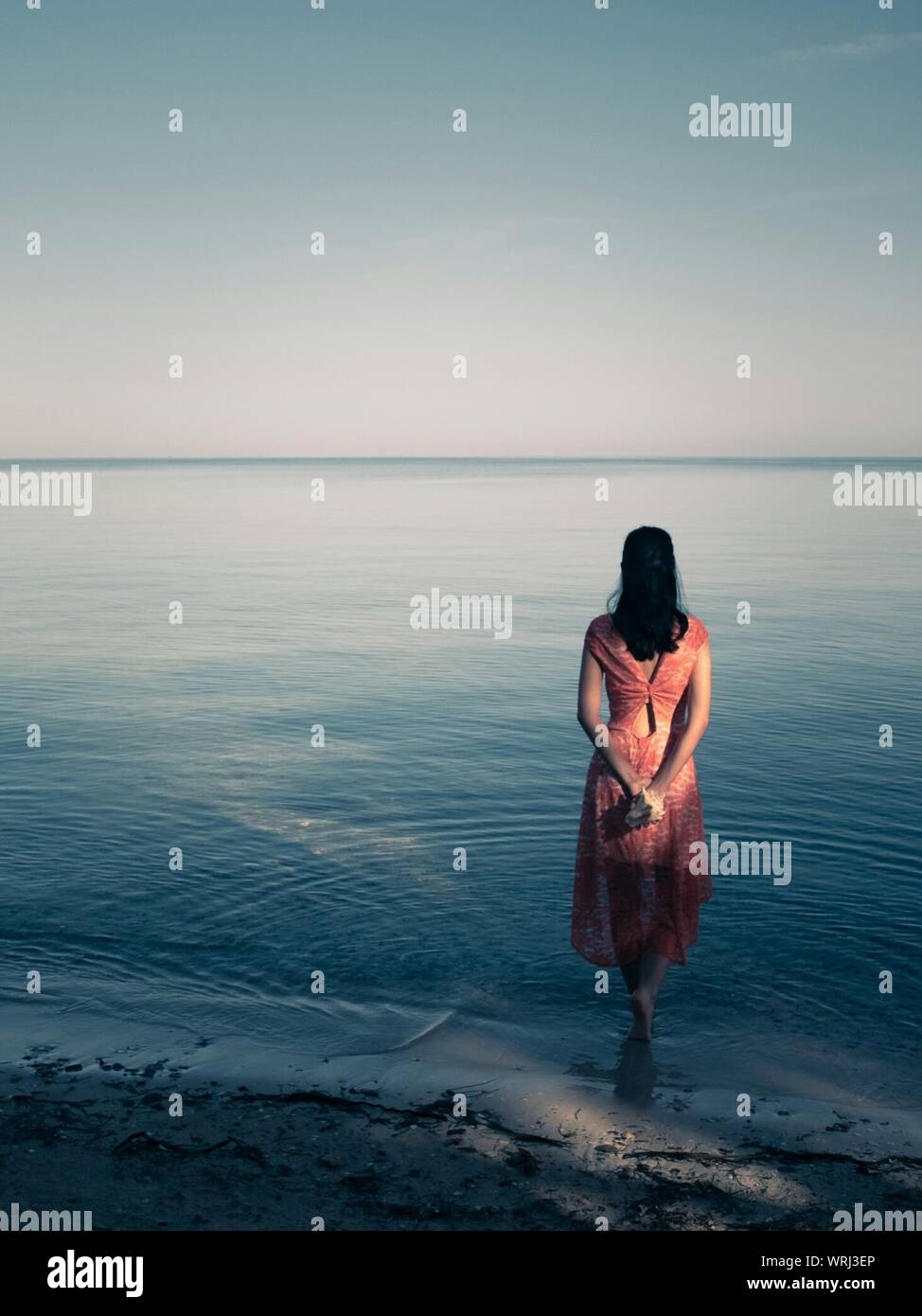 Back view woman walking sea hi-res stock photography and images - Alamy