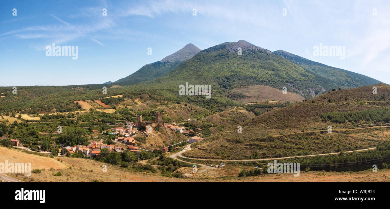 Aerial picture of medieval Aragon village of Vozmediano and castle ruins with Moncayo mountains in the background . Stock Photo