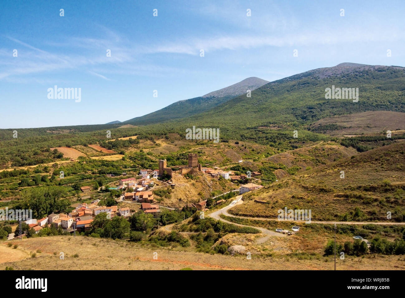 Aerial picture of medieval Aragon village of Vozmediano and castle ruins with Moncayo mountains in the background . Stock Photo