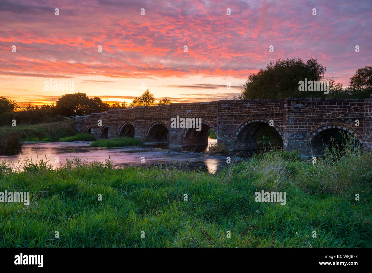 Sturminster Marshall, Dorset, UK.  10th September 2019. UK Weather.  A spectacular fiery sunset at the historic White Mill Bridge on the river Stour near Sturminster Marshall in Dorset.  Picture Credit: Graham Hunt/Alamy Live News Stock Photo