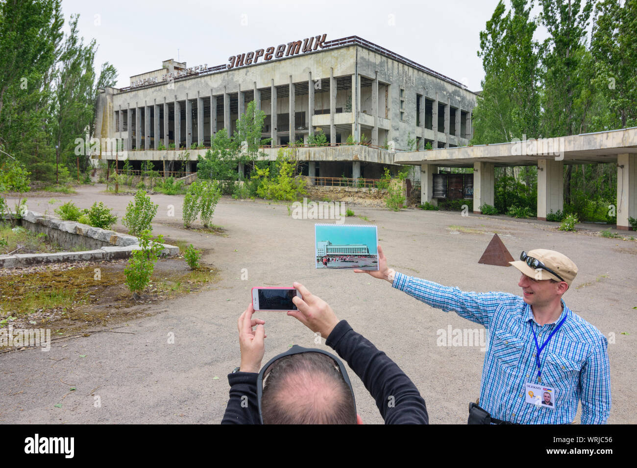 Pripyat (Prypiat): abandoned Palace of Culture Energetik, guide shows image of original look in Chernobyl (Chornobyl) Exclusion Zone, Kiev Oblast, Ukr Stock Photo