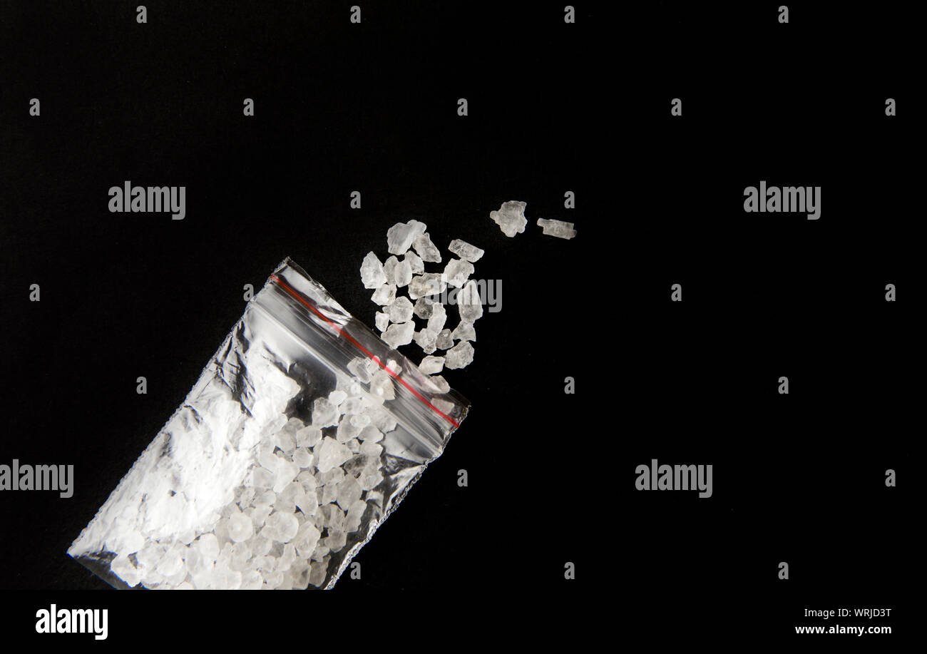 Conceptual image of 'bath salts' synthetic cathinones drugs narcotics concept. White crystal powder on black background( set up), resemble to bathroom Stock Photo