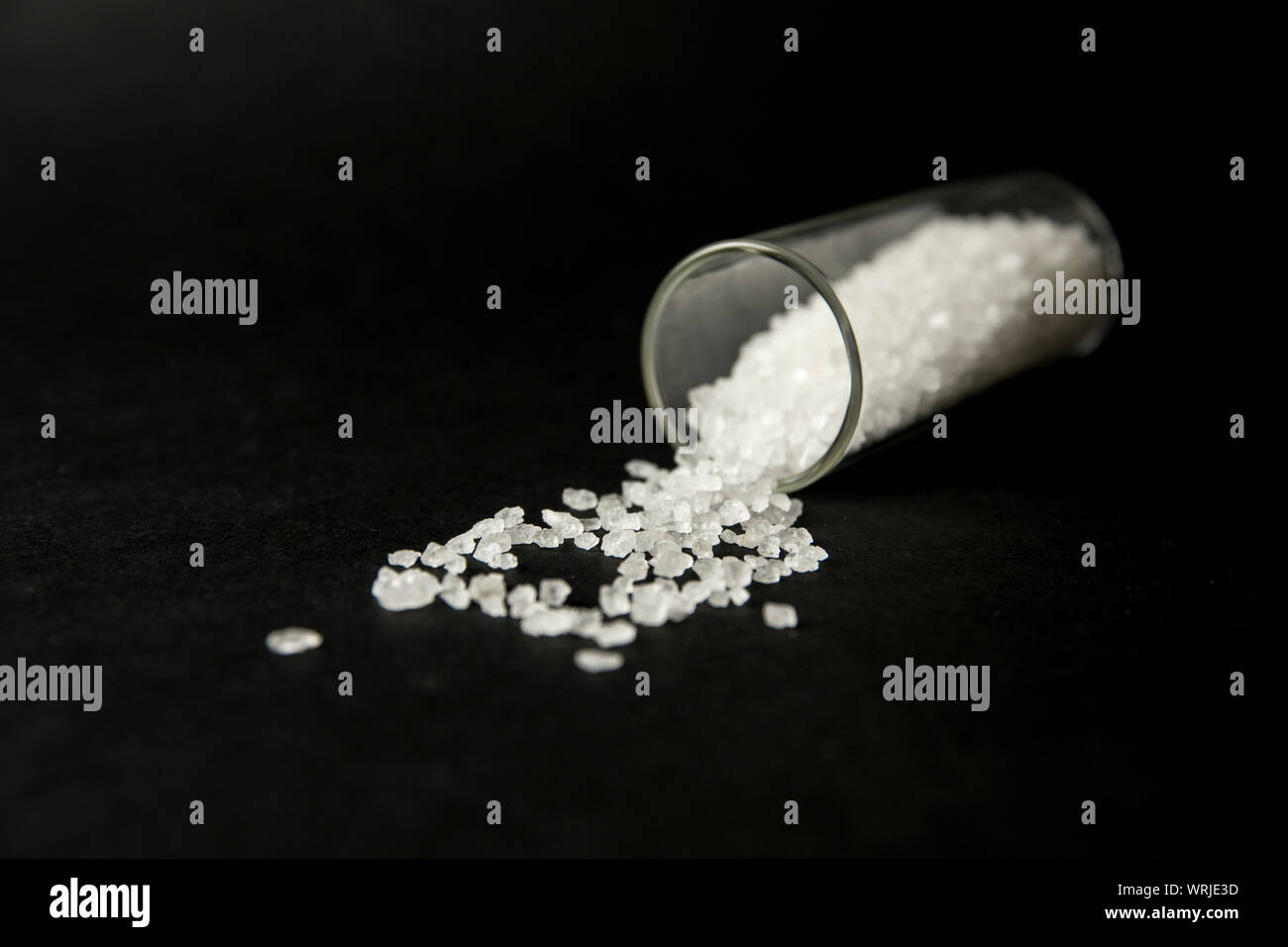Conceptual image of 'bath salts' synthetic cathinones drugs narcotics concept. White crystal powder on black background( set up), resemble to bathroom Stock Photo