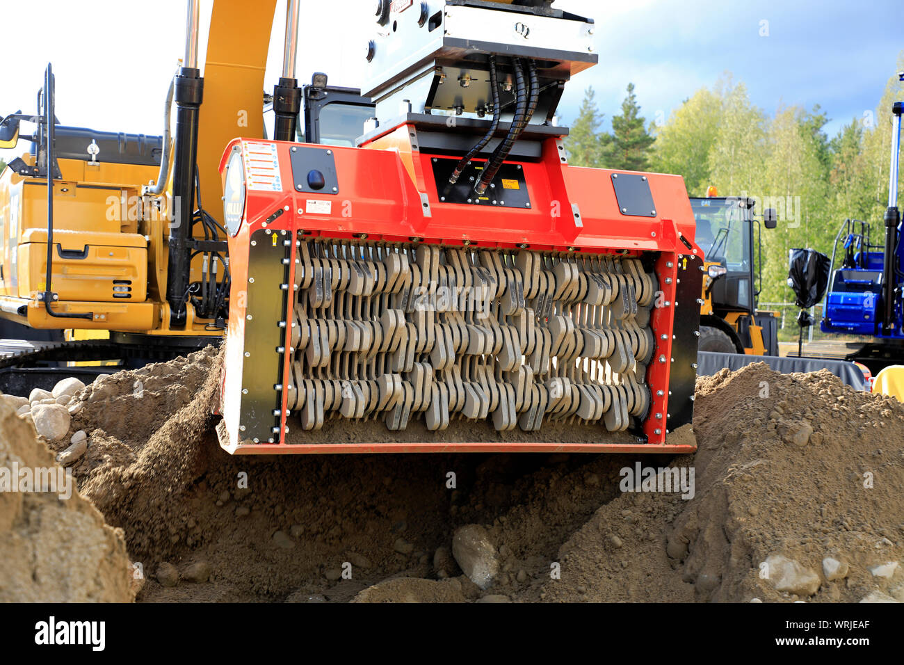Hyvinkaa, Finland. September 6, 2019. Cat excavator mounted ALLU D Transformer hydraulic screener bucket attachment screening earth on Maxpo 2019. Stock Photo