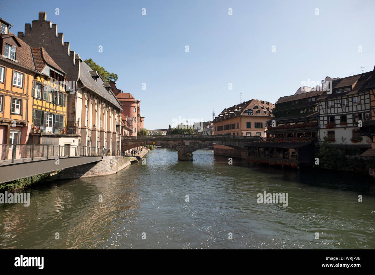 The Pont St Martin crosses the canal amid traditional historic buildings in the Petite France area of Strasbourg, France. Stock Photo