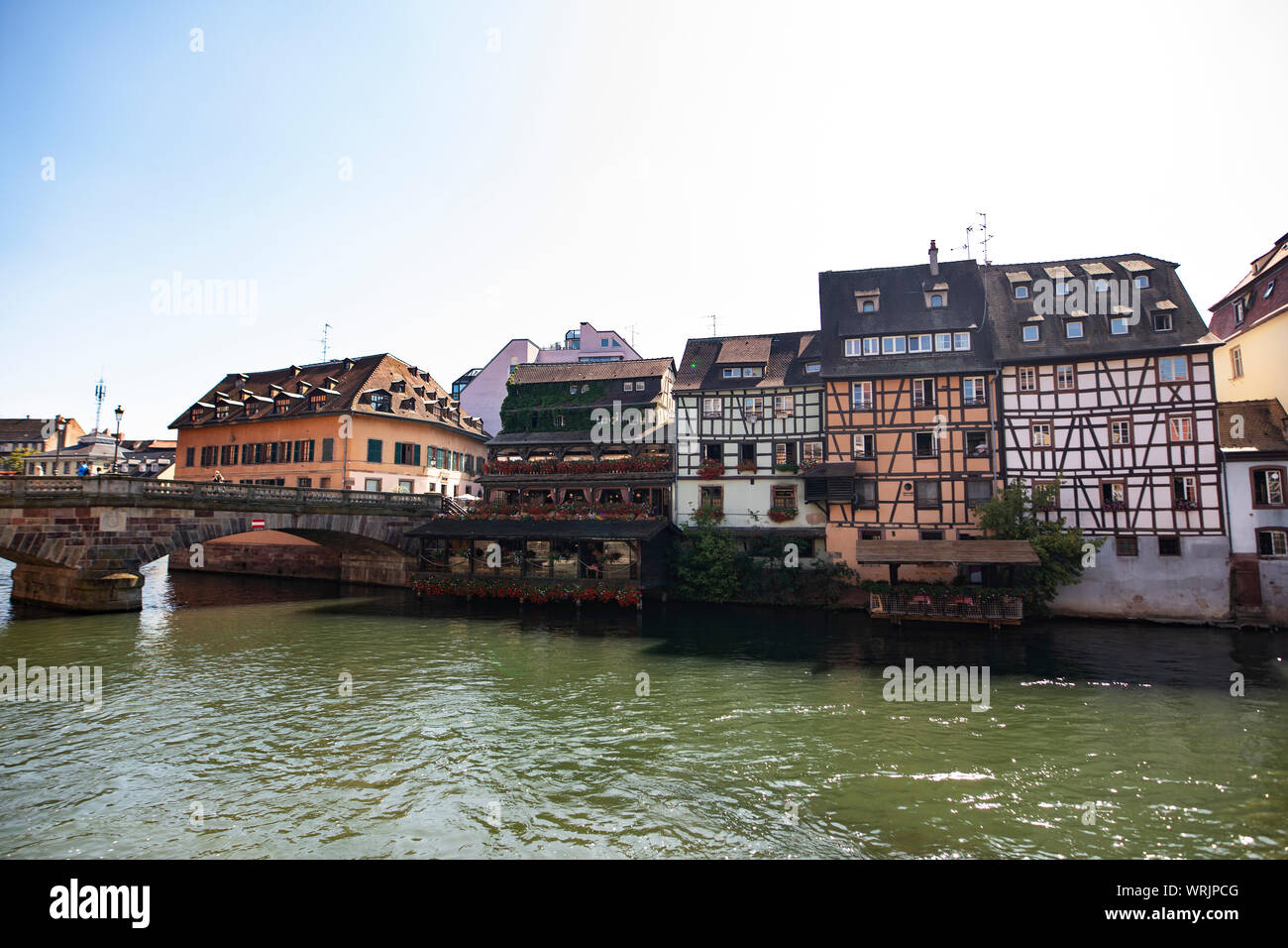 The Pont St Martin crosses the canal amid traditional historic buildings in the Petite France area of Strasbourg, France. Stock Photo