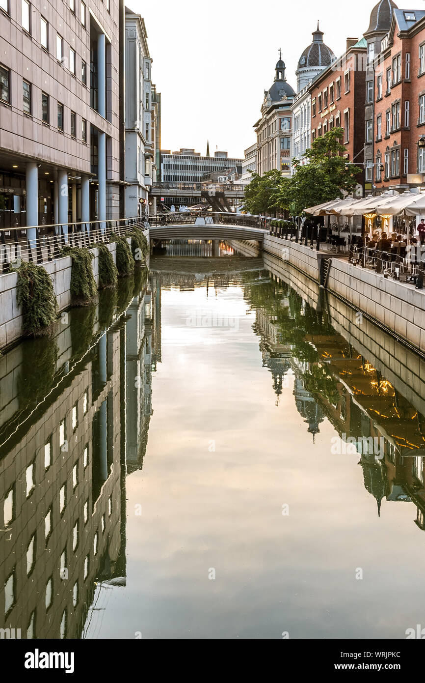 Downtown Aarhus with the canal and restaurants in the evening, reflecting in the water, Denmark, July 15, 2019 Stock Photo