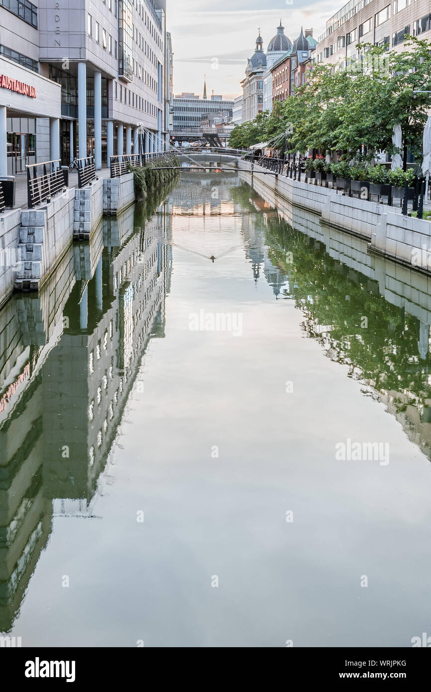 Downtown Aarhus with the canal and sidewalk reflecting in the water with space for copy, Denmark, July 15, 2019 Stock Photo