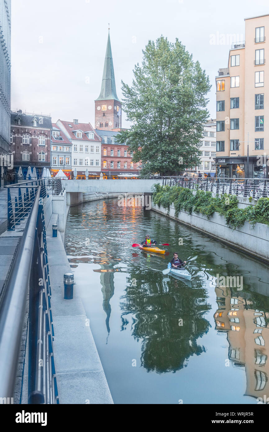 Aarhus cathedral reflecting in the water and two kayaks paddling in the river, Denmark. July 15, 2019 Stock Photo