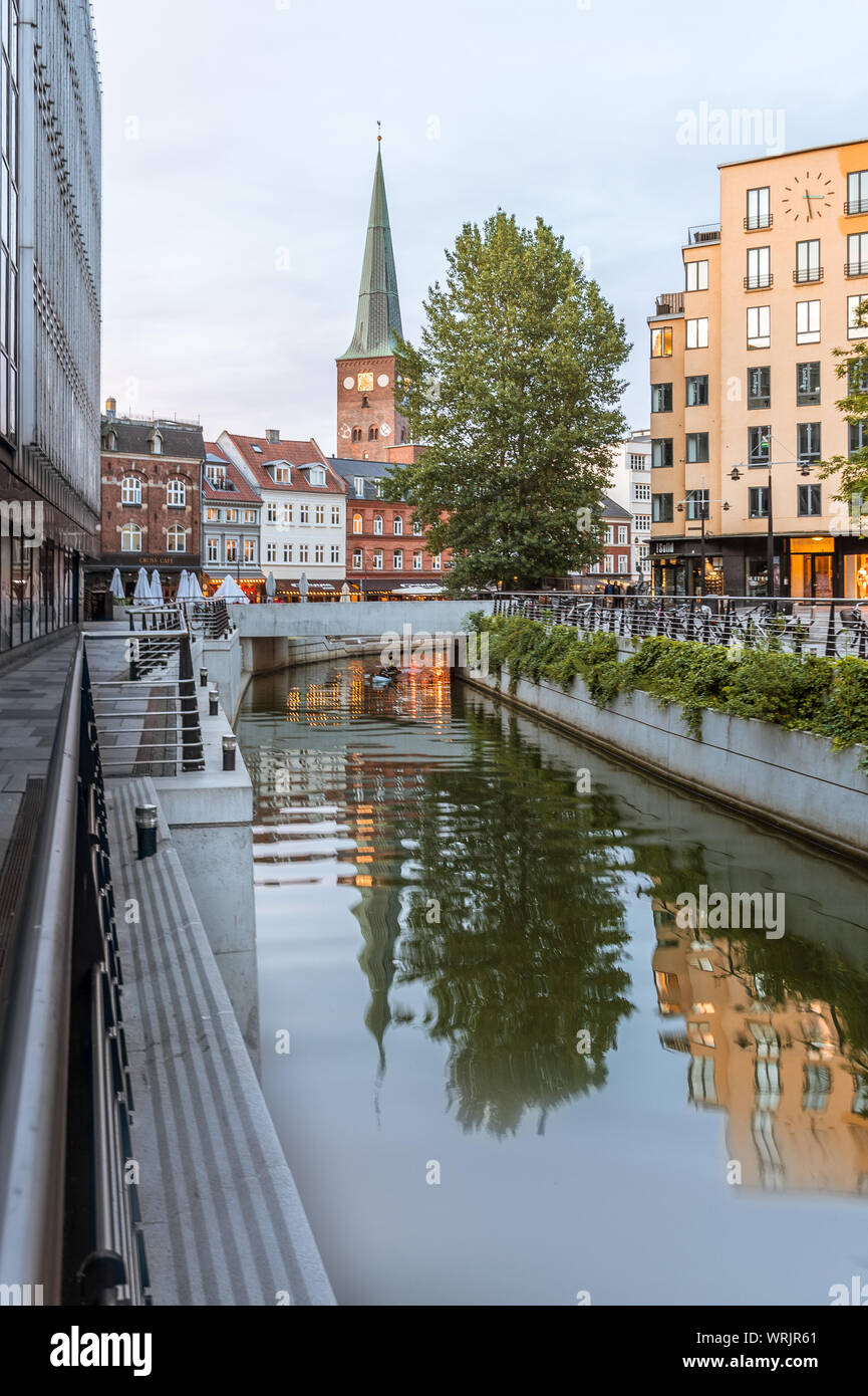 Aarhus cathedral reflecting in the river and kayaks paddling under a bridge, Denmark. July 15, 2019 Stock Photo