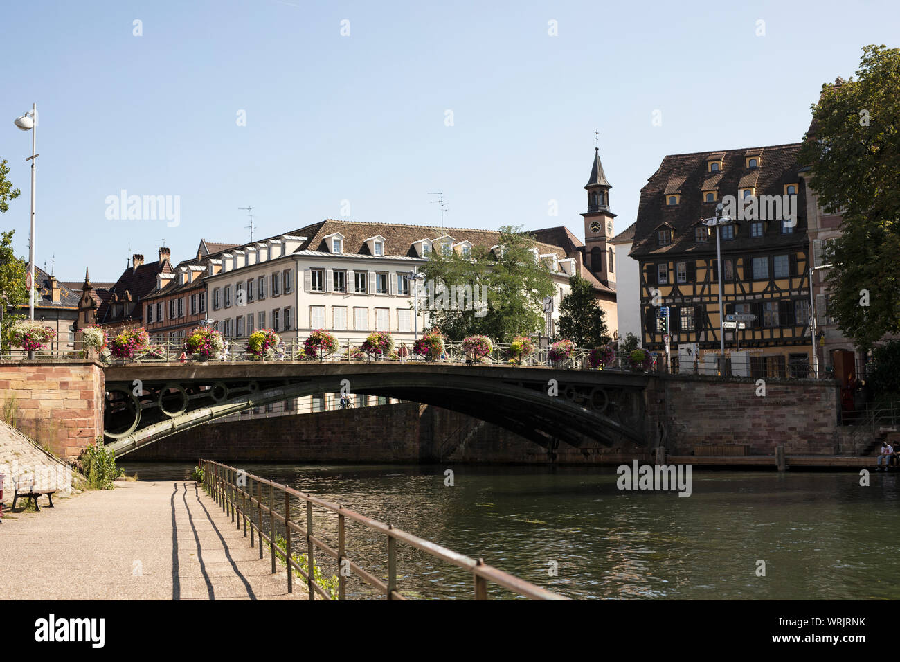 The Pont Saint Thomas bridge over the canal in the Petite France neighborhood of Strasbourg, France, near the Saint-Louis de Strasbourg church. Stock Photo