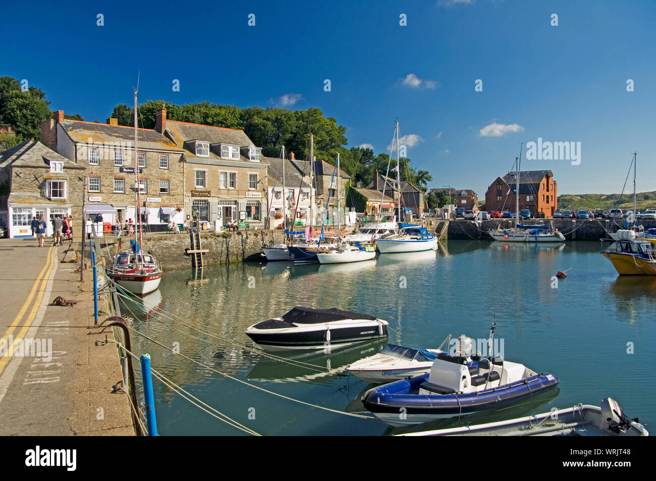 The beautiful harbour at Padstow, Cornwall, England where fishing boats lie beside luxury sailing yachts Stock Photo