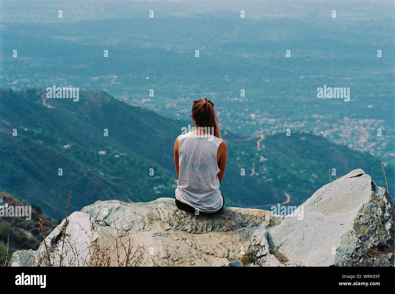 Woman sitting on mountain hi-res stock photography and images - Alamy
