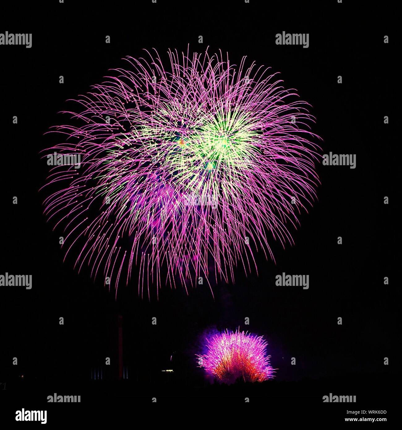 Colorful Fireworks Display In Sky At Night Stock Photo