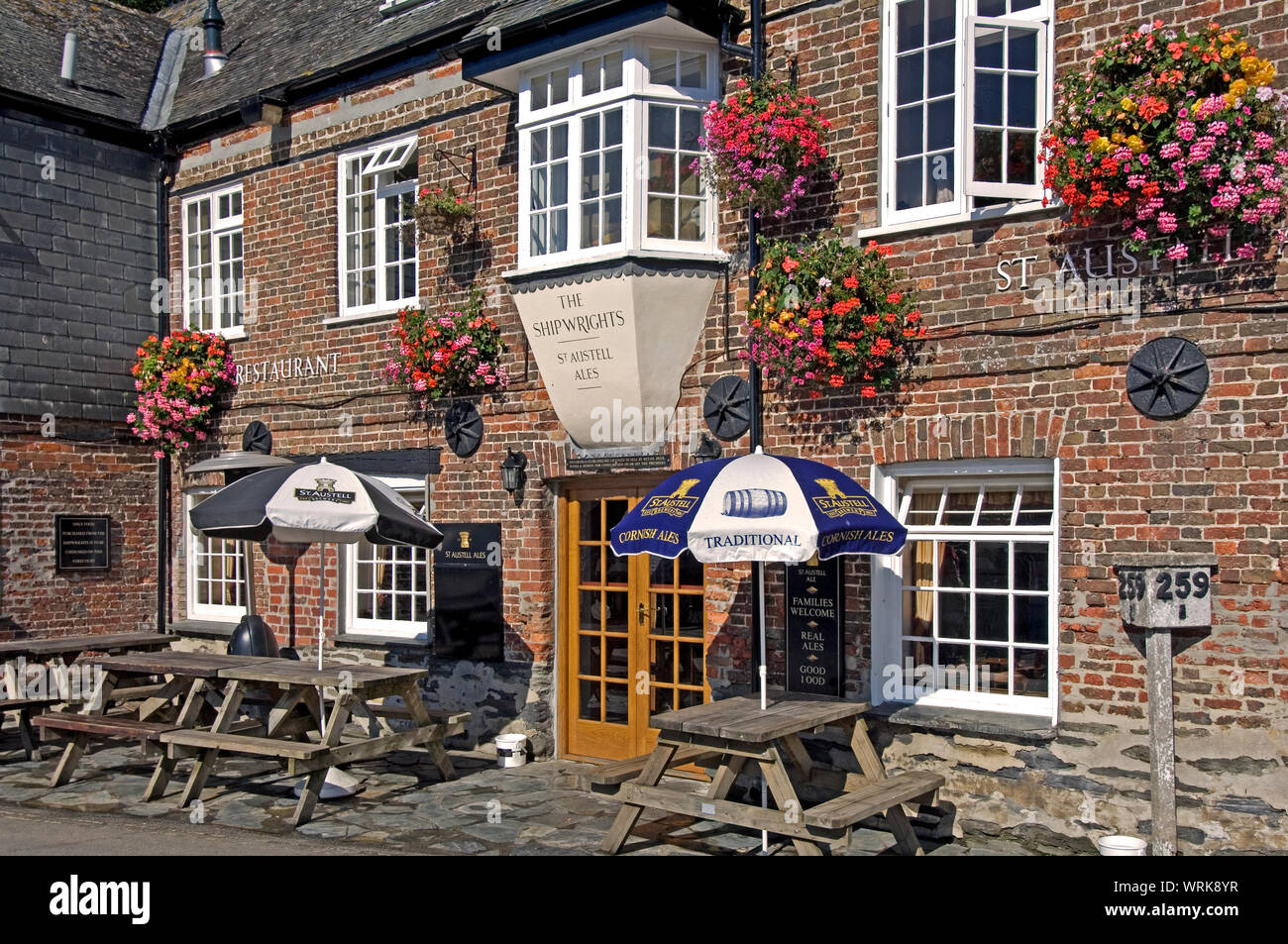 The buildings around the harbor at Padstow, Cornwall, England are built of warm toned brick, such as in this pub Stock Photo