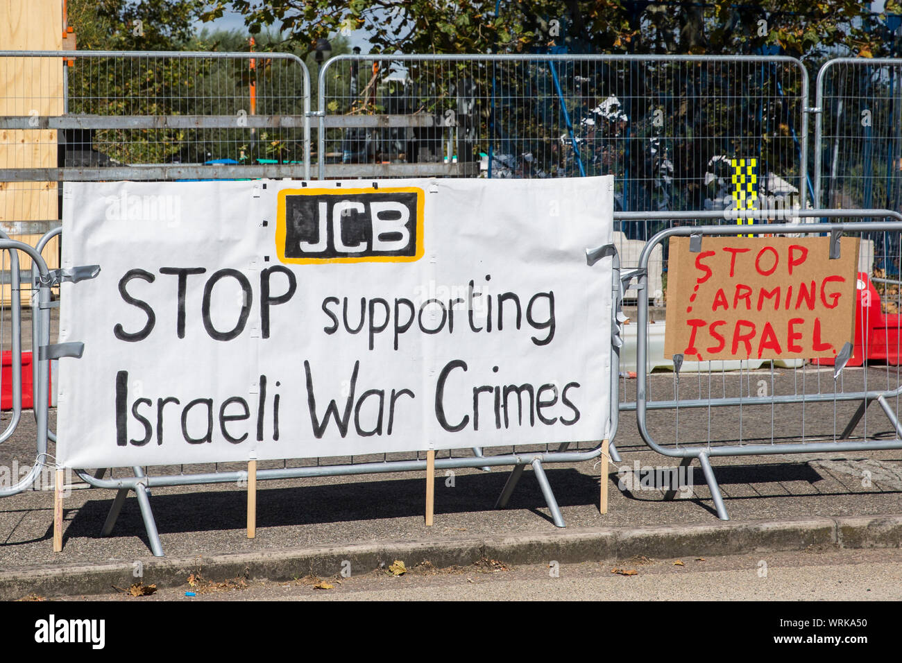 London, UK. 2 September, 2019. A banner referencing JCB hung by pro-Palestinian activists protesting outside ExCel London on the first day of week-lon Stock Photo
