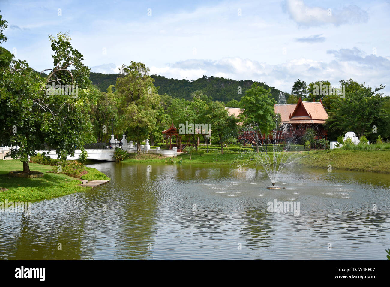 Kanchanaburi, Thailand, 09.09.2019: Beautiful garden, lake, traditional Thai, Siamese clothes, buildings of 'Mallika City R.E. 124' a heritage, retro- Stock Photo
