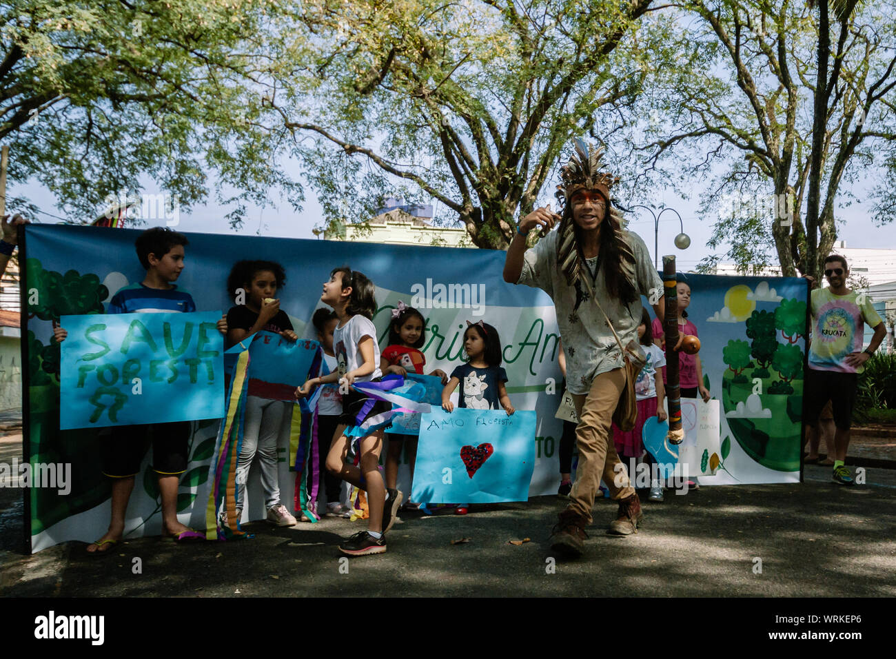 Children in front of a banner with a indigenous protester in a pro environment walk, protest during the brazilian independence day Stock Photo
