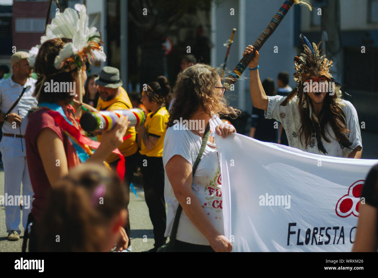 Crowd in the streets with a protester dressed as indigenous in a pro environment walk, protest during the brazilian independence day Stock Photo