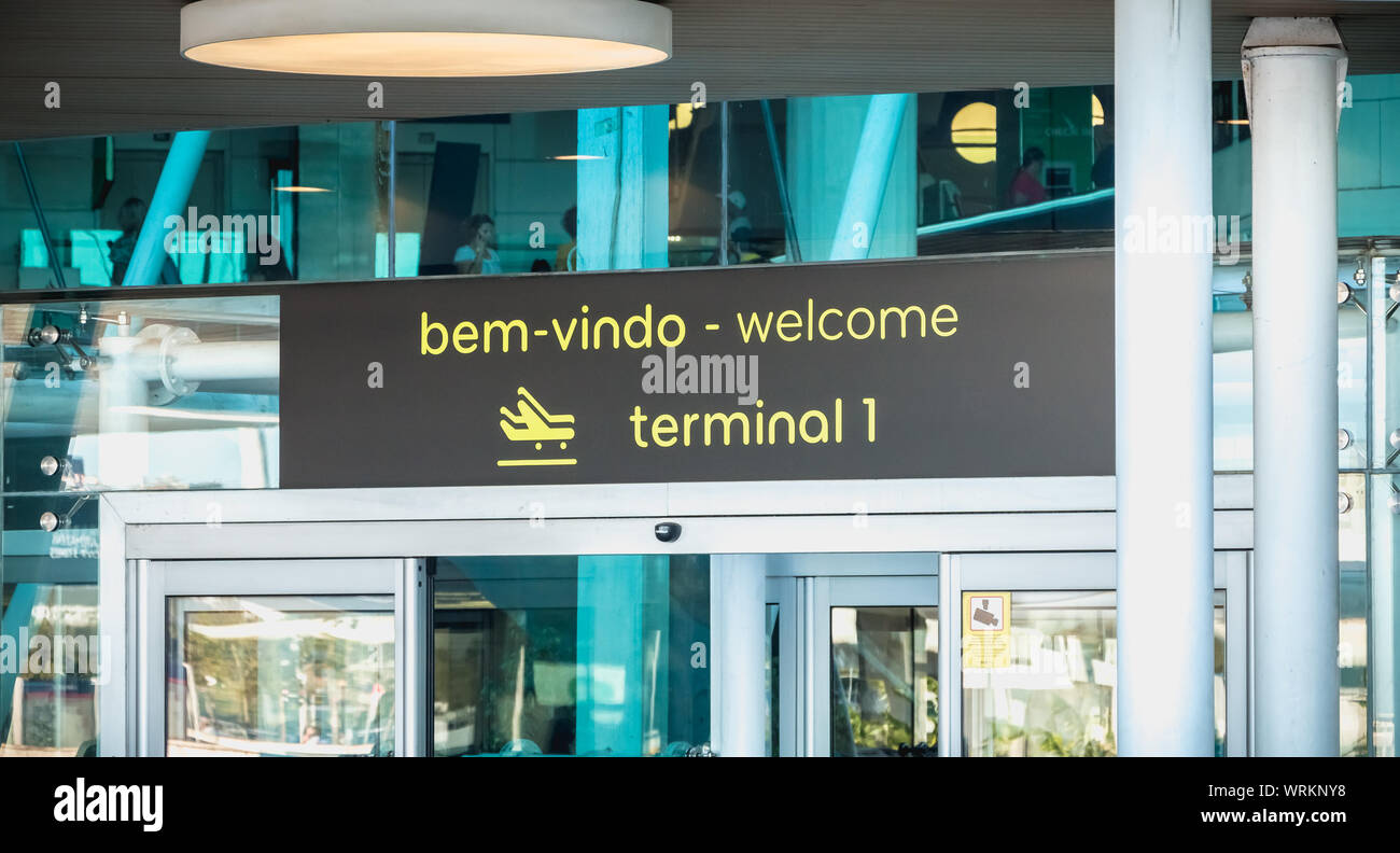 Lisbon, Portugal - August 7, 2018: exterior view of Lisbon International Airport where travelers walk on a summer day Stock Photo
