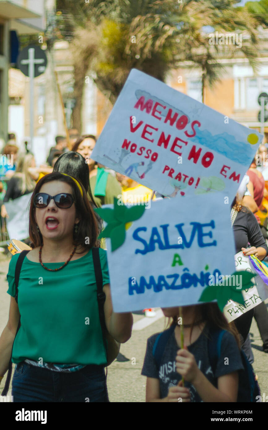Crowd in the streets with women holding a manifestation banner, in a pro environment walk, protest during the brazilian independence day Stock Photo