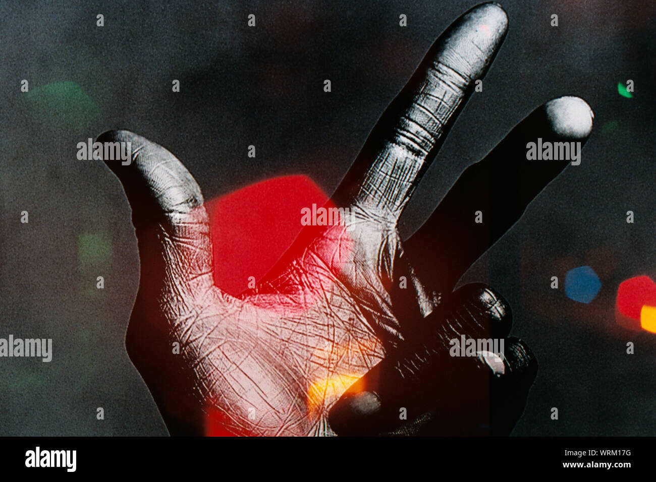 Digital Composite Of Cropped Hand Gesturing At Night Stock Photo