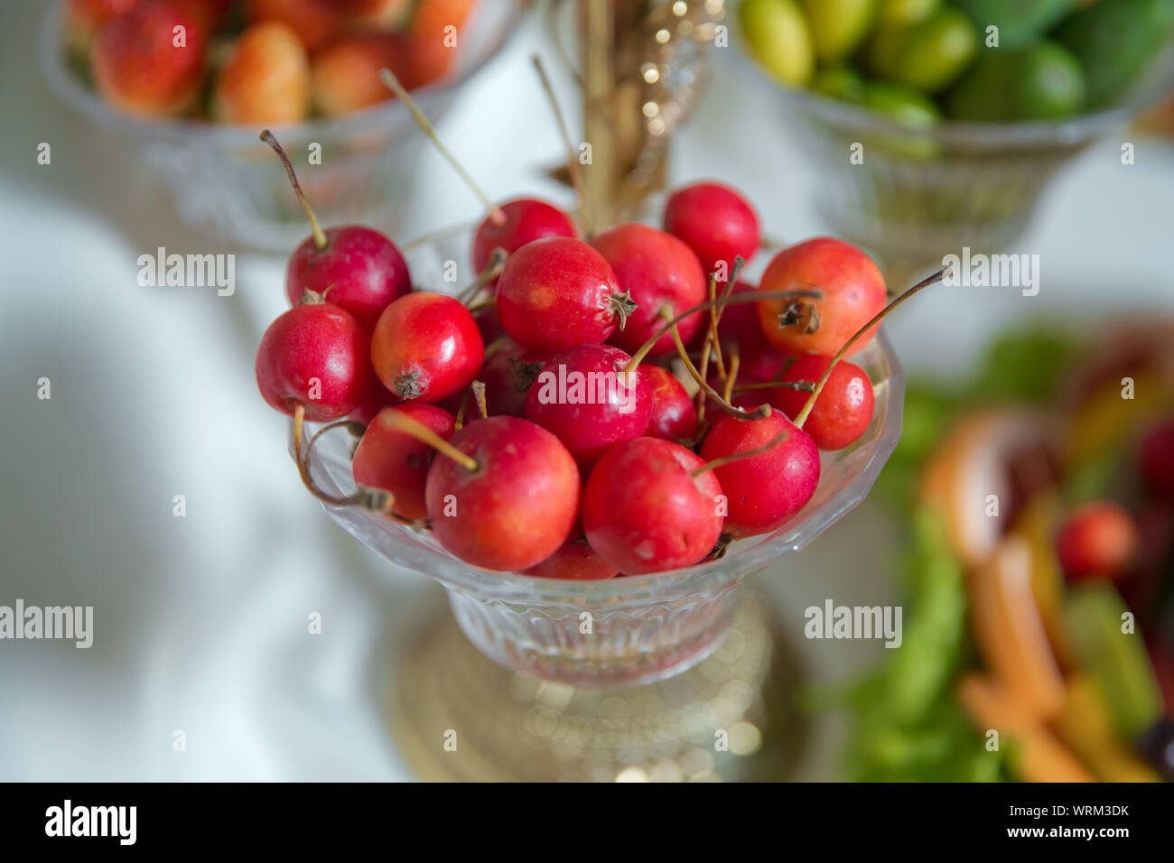 Red crab apple in a glass jar . Hand dipped caramel crab apples Stock