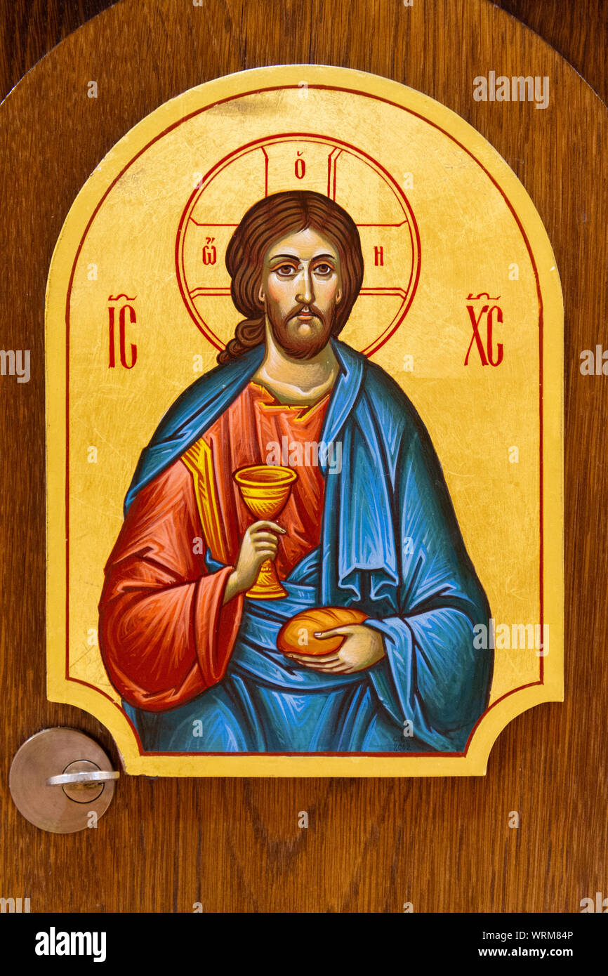 The icon of Jesus Christ with bread and wine in His hands. The icon is on the Eucharistic tabernacle. The Greek Catholic Church of Saint Elijah. Stock Photo