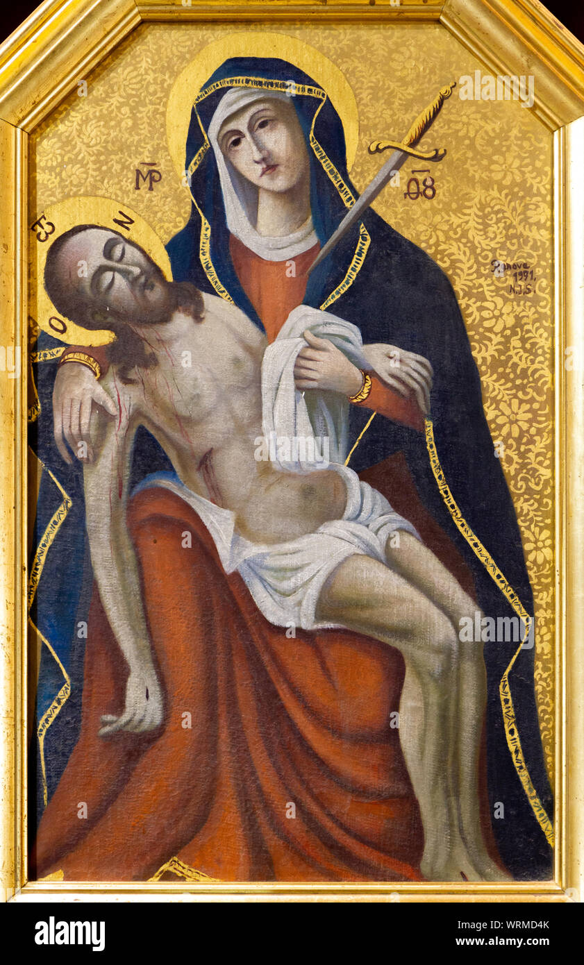 The painting of the Virgin Mary grieving over her crucified son Jesus Christ - a Pieta. The Greek Catholic church of Saint Elijah. Stock Photo