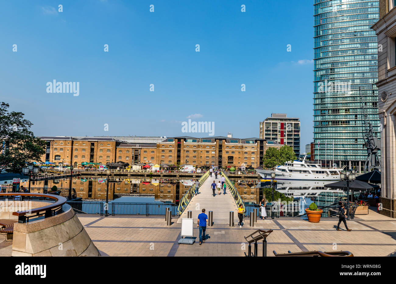 View of the West India Quay, the North Dock and the North Dock pedestrian bridge, in Canary Wharf Estate, London, England. Stock Photo