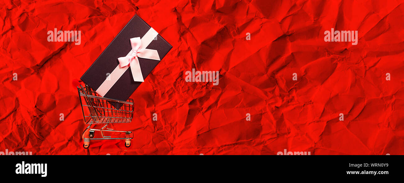 Holiday gift, Black Friday concept with gift box and pink bow in a